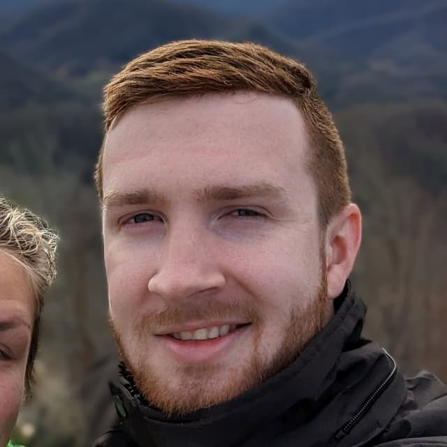 Greg standing on a mountaintop